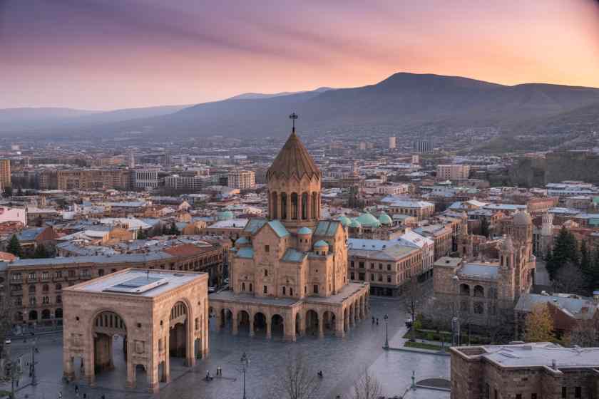 Yerevan cityscape at dusk with Mount Ararat rising behind it in Armenia